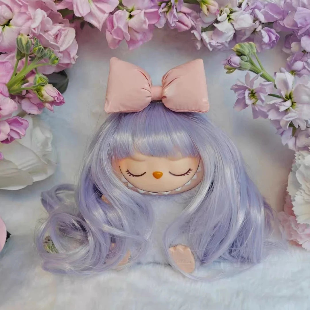 Dreams Curly Accessory on 17cm plush doll: lavender/lilac curly wig with full, face-framing bangs, oversized pink satin bo...