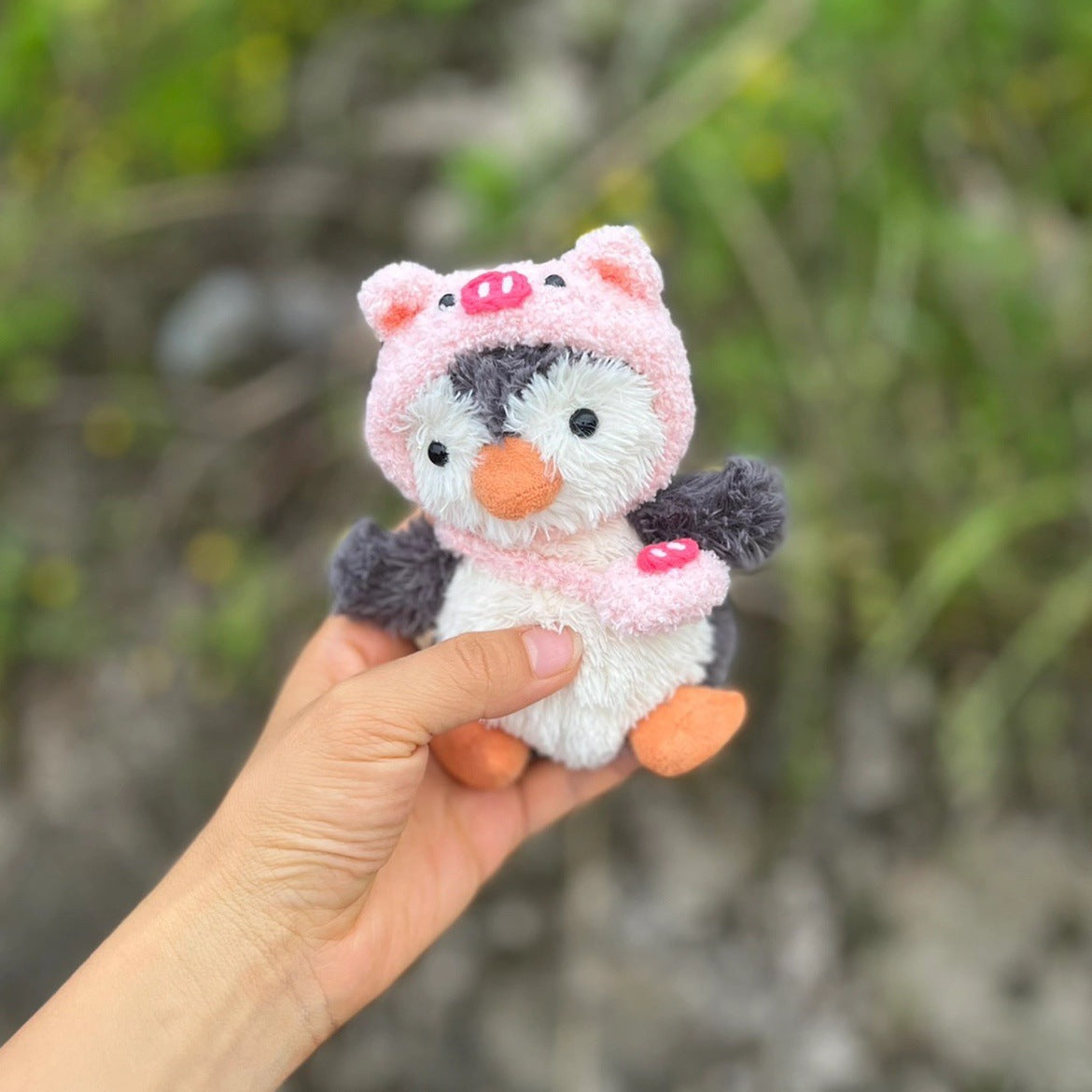 Piggy Hat Outfit on 15cm plush penguin: pink fuzzy piggy hat with ears and snout detail, matching pink piggy accessory clip.