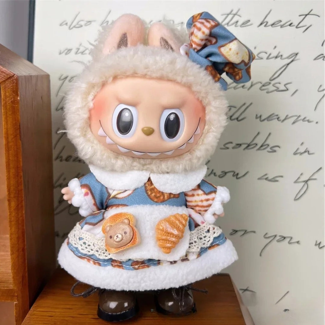 Bakery-Themed Dress Outfit on 17cm plush doll: blue bakery-print dress with soft white fleece trim and lace accents, match...