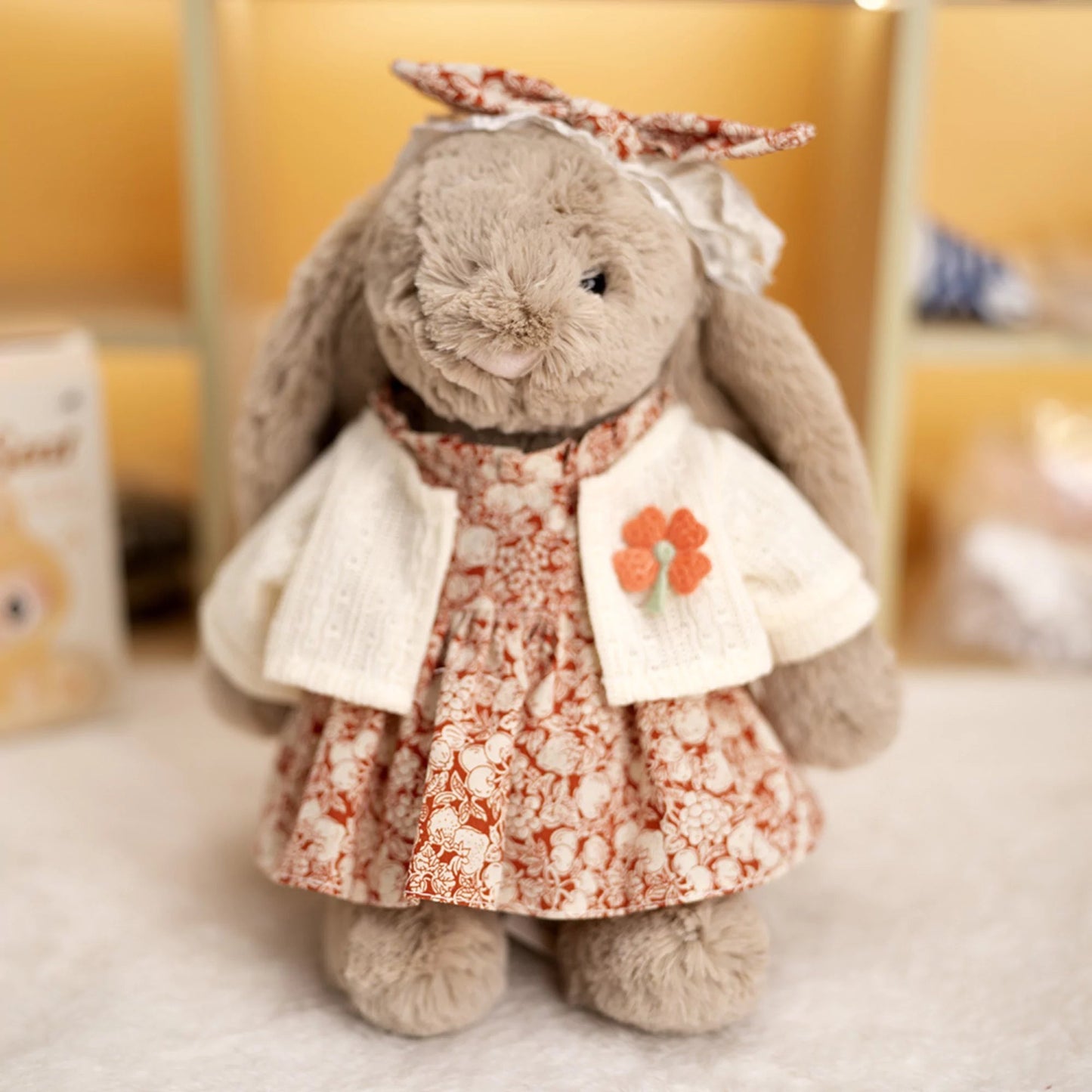 Floral Dress on 31cm plush rabbit: red-orange floral print dress with all-over bloom pattern, cream knit cardigan with han...