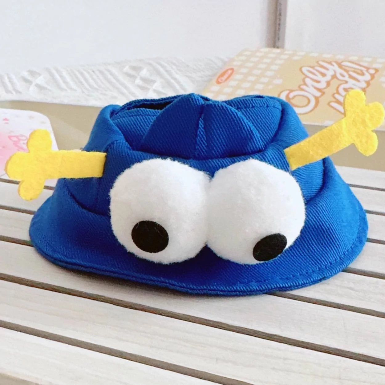 Monster Hat Accessory on 17cm plush doll: royal blue monster hat with gathered top, two oversized white pom-pom eyes with...