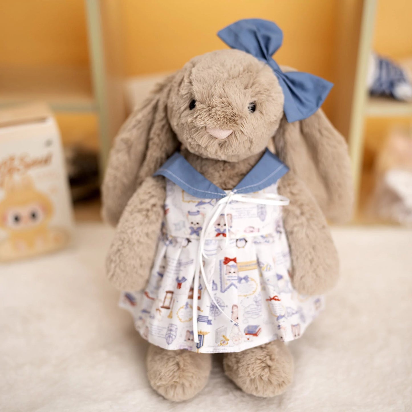 Illustrated Print Dress on 31cm plush rabbit: illustrated character-print dress with dusty blue peter pan collar, thin rib...