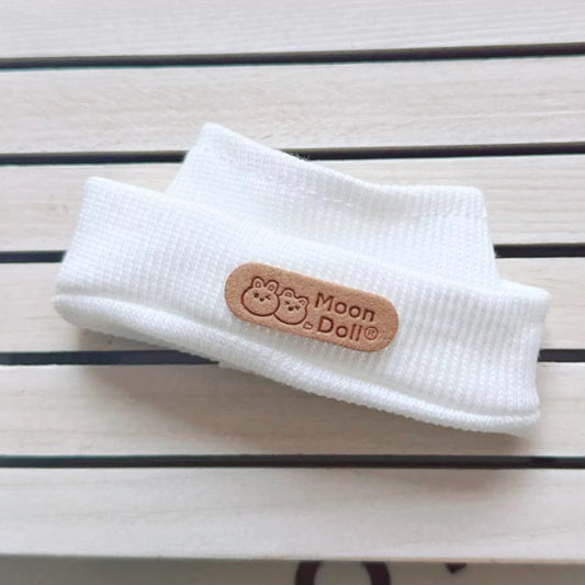 White Ribbed Headband on 17cm plush doll: white ribbed knit headband with leather brand label, a minimalist, sporty access...