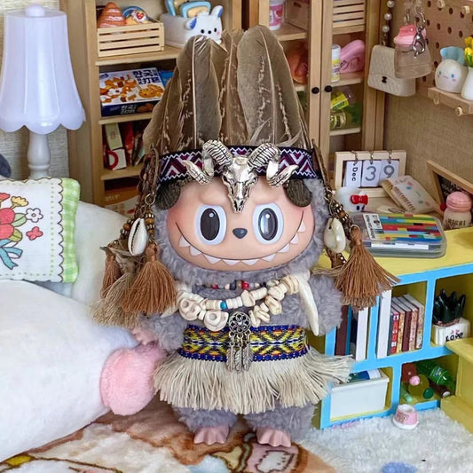 Tribal Warrior Outfit on 17cm plush doll: feathered headdress with geometric woven band, skull/medallion centerpiece on he...