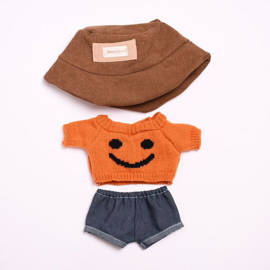 Smiley Knit Sweater on 38cm plush doll: orange hand-knit short-sleeve sweater with black intarsia smiley face pattern, dar...