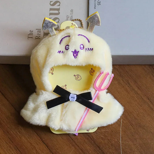 Chick Cape Skirt on 17cm plush doll: pale yellow plush chick-face hooded cape, black satin ribbon bow with button detail.