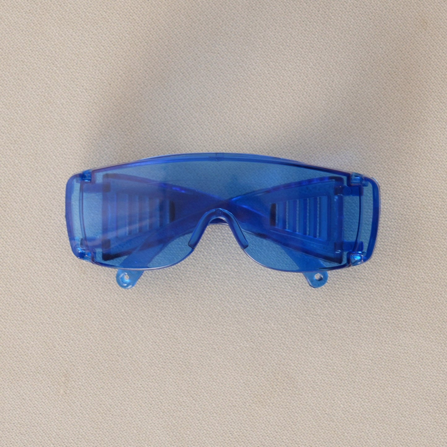 Futuristic Blue Sunglasses on 17cm plush doll: pair of futuristic wraparound sunglasses, color: translucent cobalt blue.