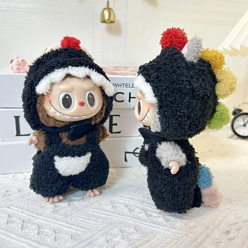 Pom Pom Costume on 17cm plush doll: full-body black sherpa dino onesie with hood, red and multicolor yarn pom pom spines a...