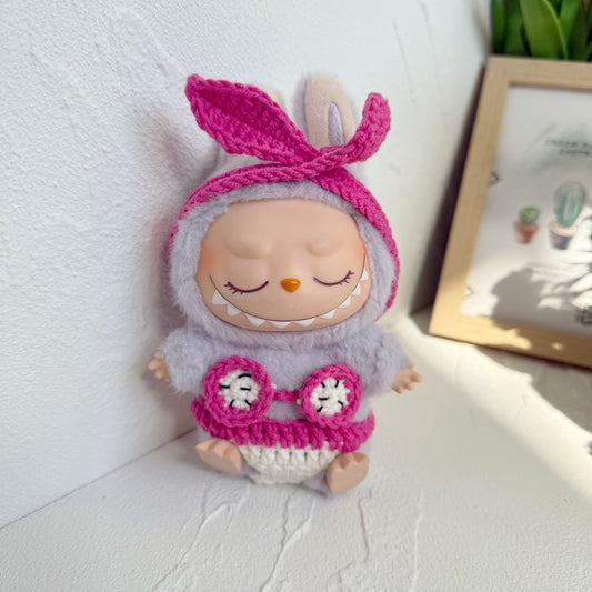Crocheted Knit Bikini Outfit on 17cm plush doll: hot pink crocheted bunny-ear headband with knotted bow detail, matching c...