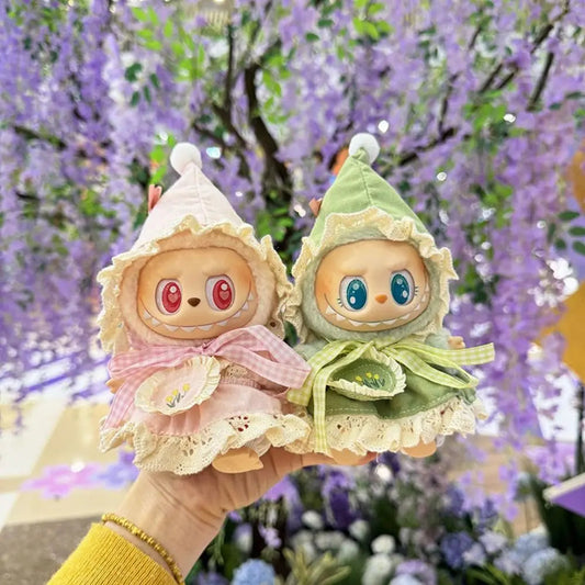 Elf Hooded Outfit on 17cm plush doll: handmade pastel elf hooded cape with pointed hood, lace trim, and layered ruffle det...