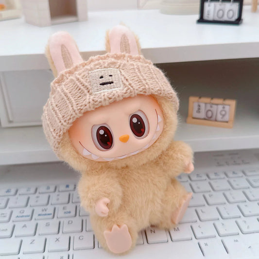 Beige Knit Beanie on 17cm plush doll: beige ribbed knit beanie hat, embroidered smiley face patch detail.