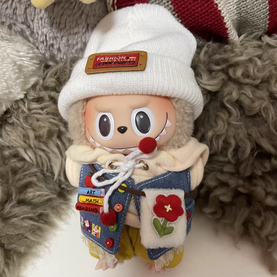 Market Day Outfit on 17cm plush doll: white knit beanie with woven "fashion" label, cream hoodie with drawstring detail.