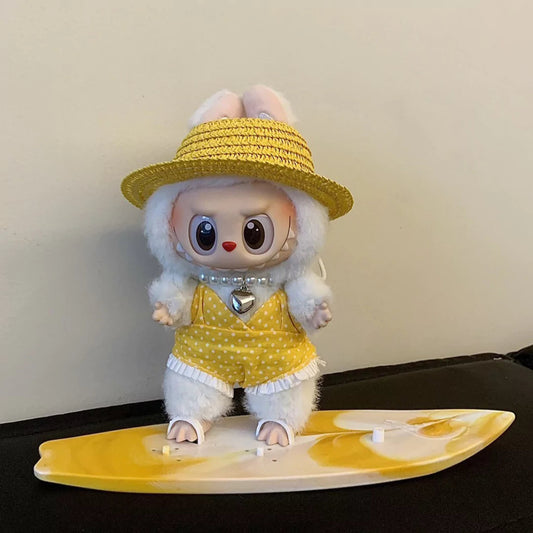 Yellow Surfer Outfit on 17cm plush doll: yellow polka-dot romper with white ruffle hem, woven straw sun hat.